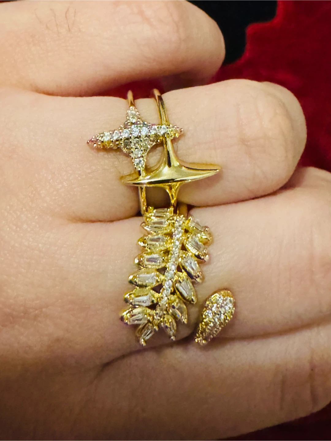 Gold-tone ring with star and leaf design
