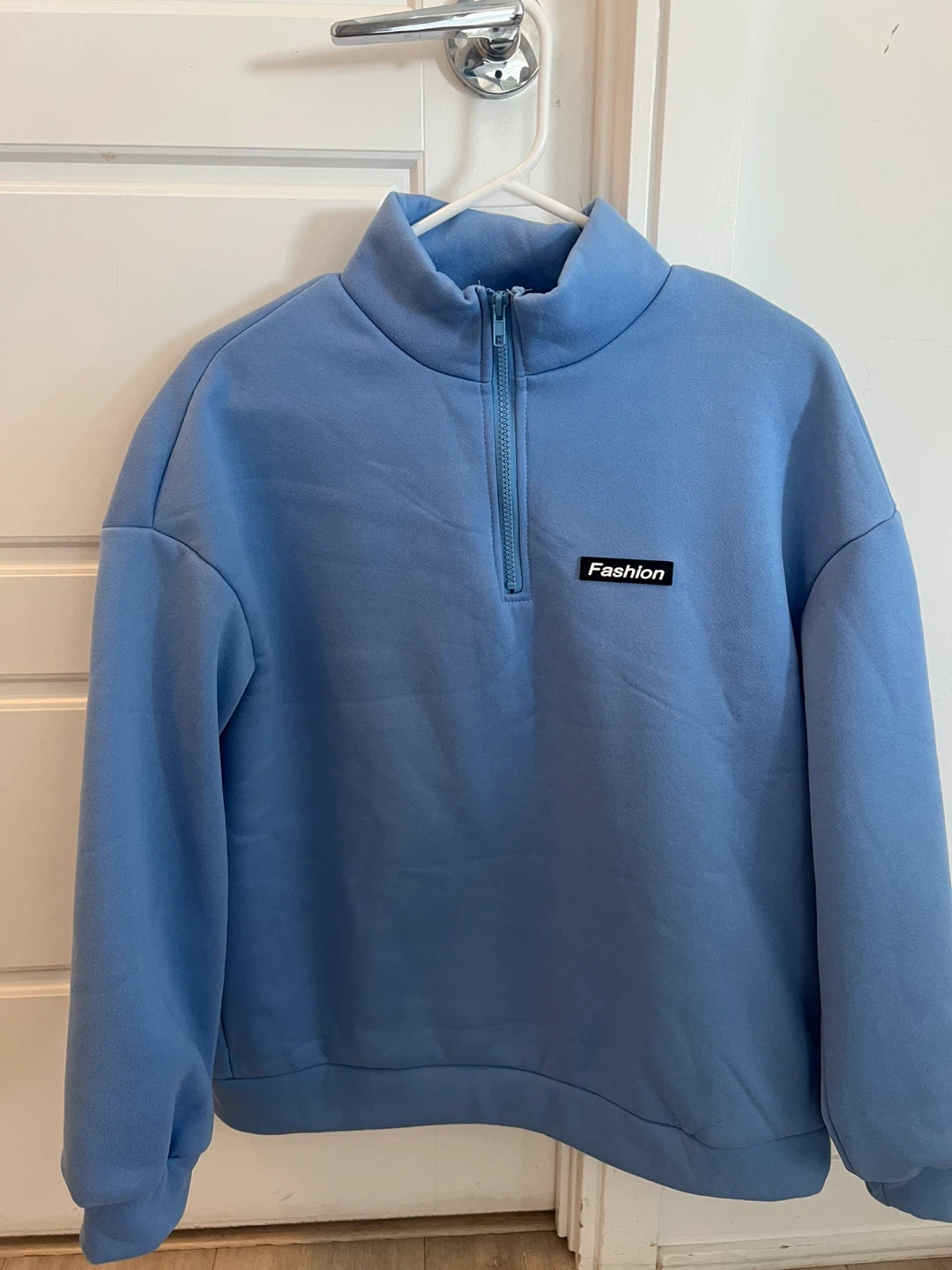Blue Quarter-Zip Sweatshirt with "Fashion" Patch