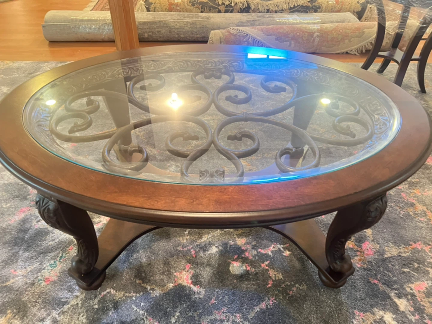 Oval Coffee Table with Glass Top and Ornate Metal Insert