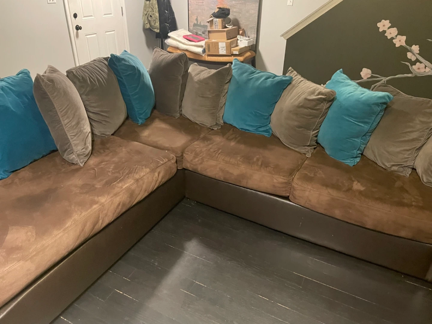 Brown Sectional Couch with Teal and Tan Pillows