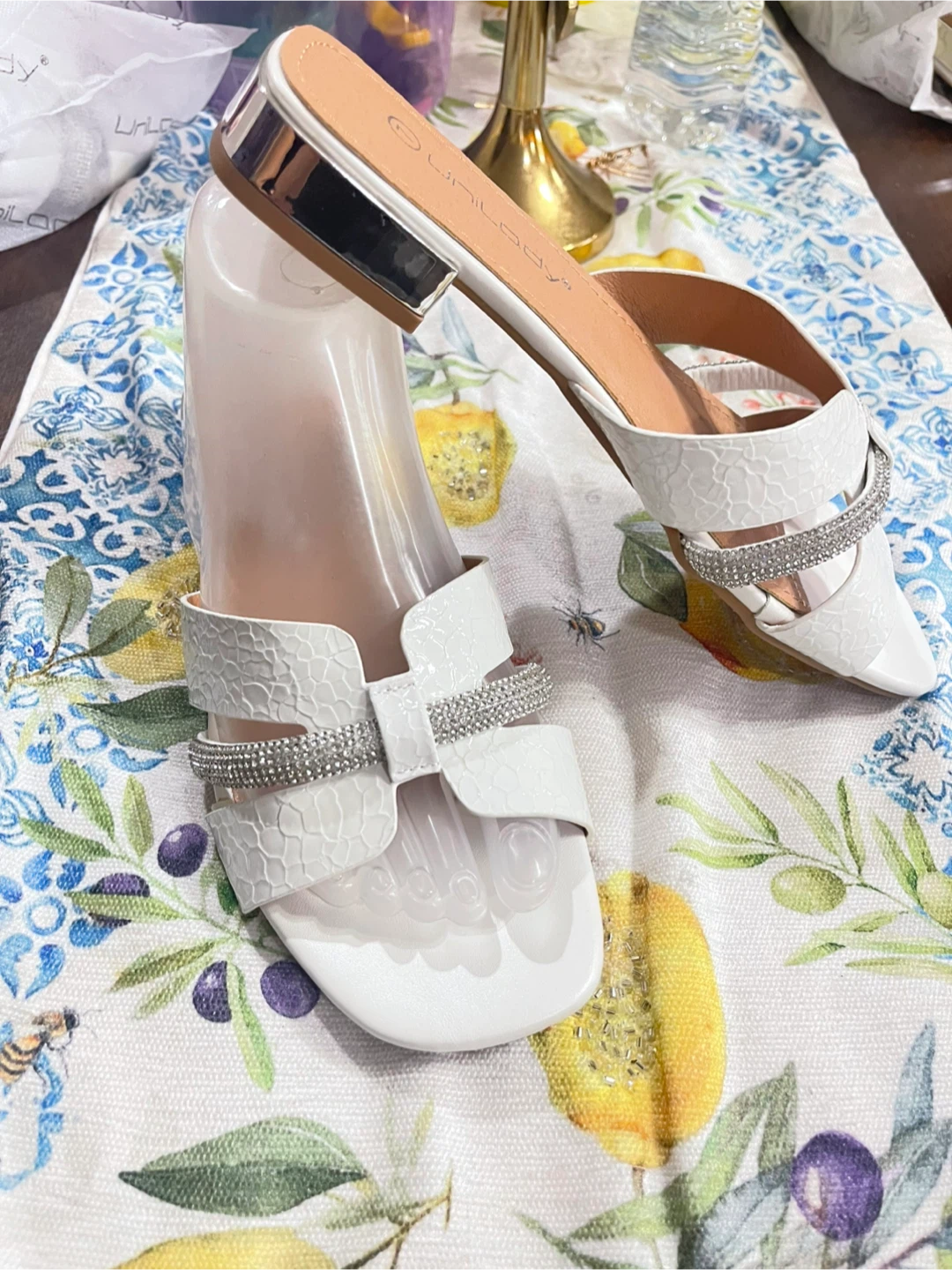 White slip-on sandals with rhinestones