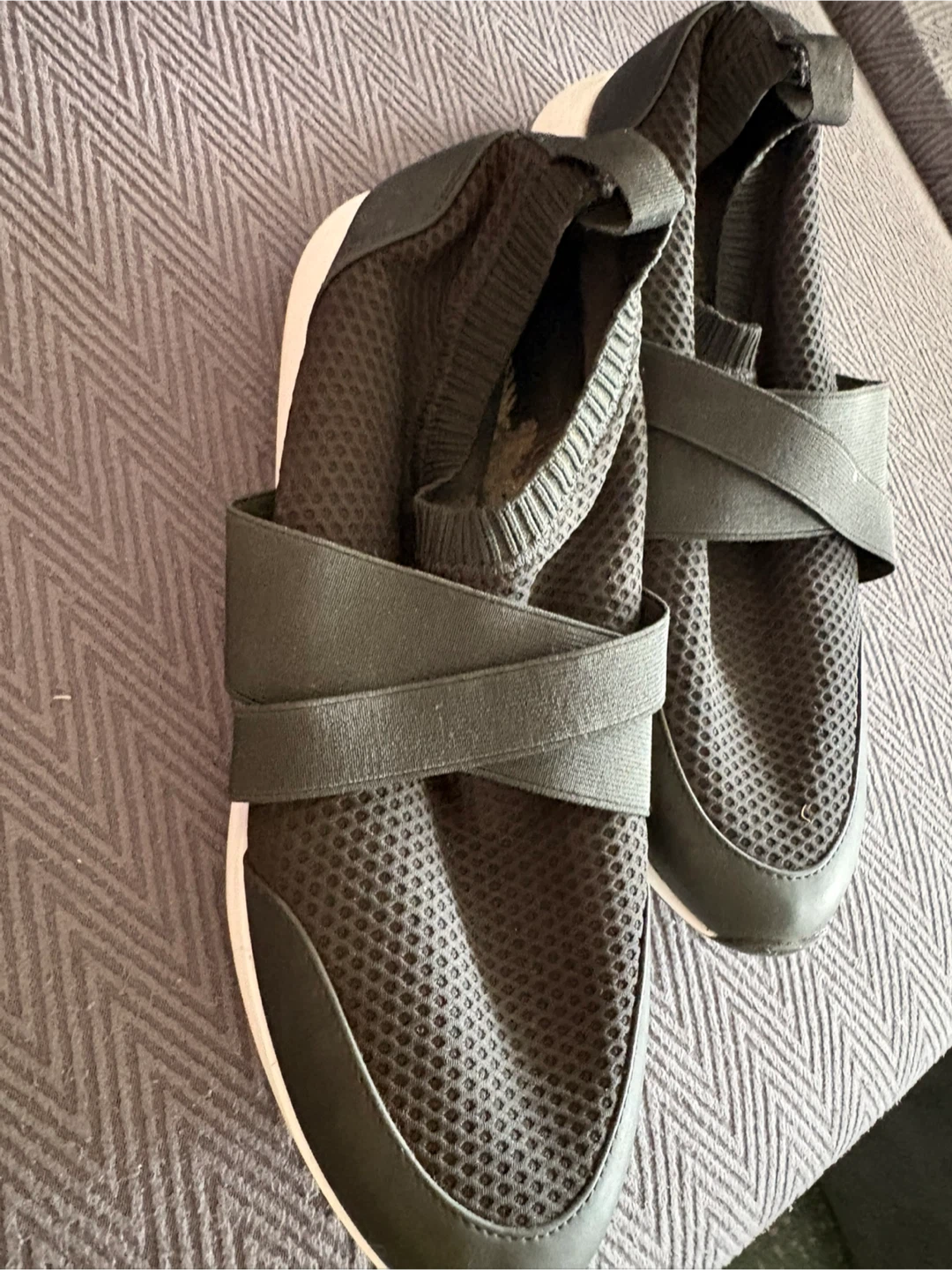 Black slip-on sneakers with elastic criss-cross straps