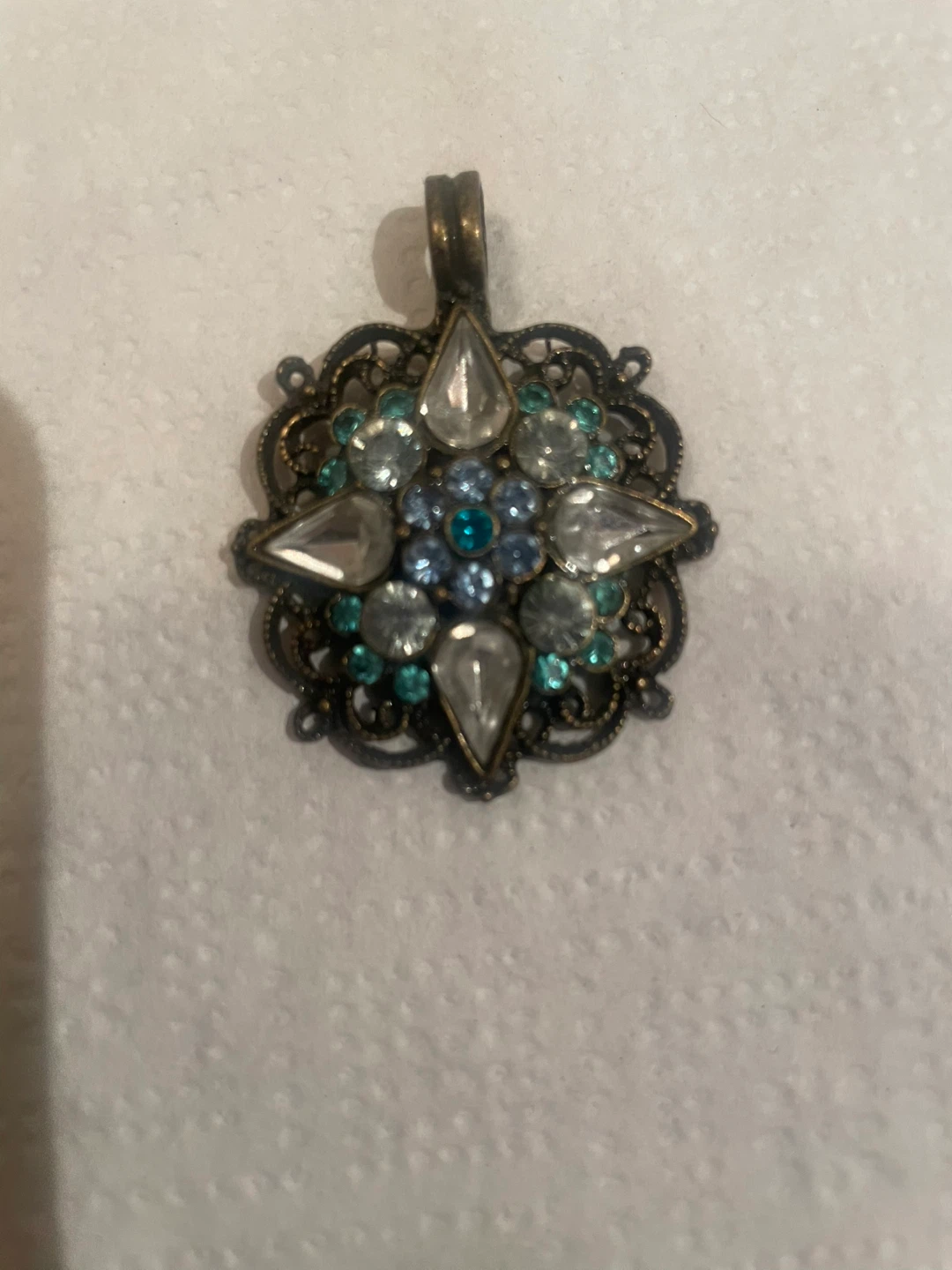 Ornate filigree pendant with blue and clear rhinestones