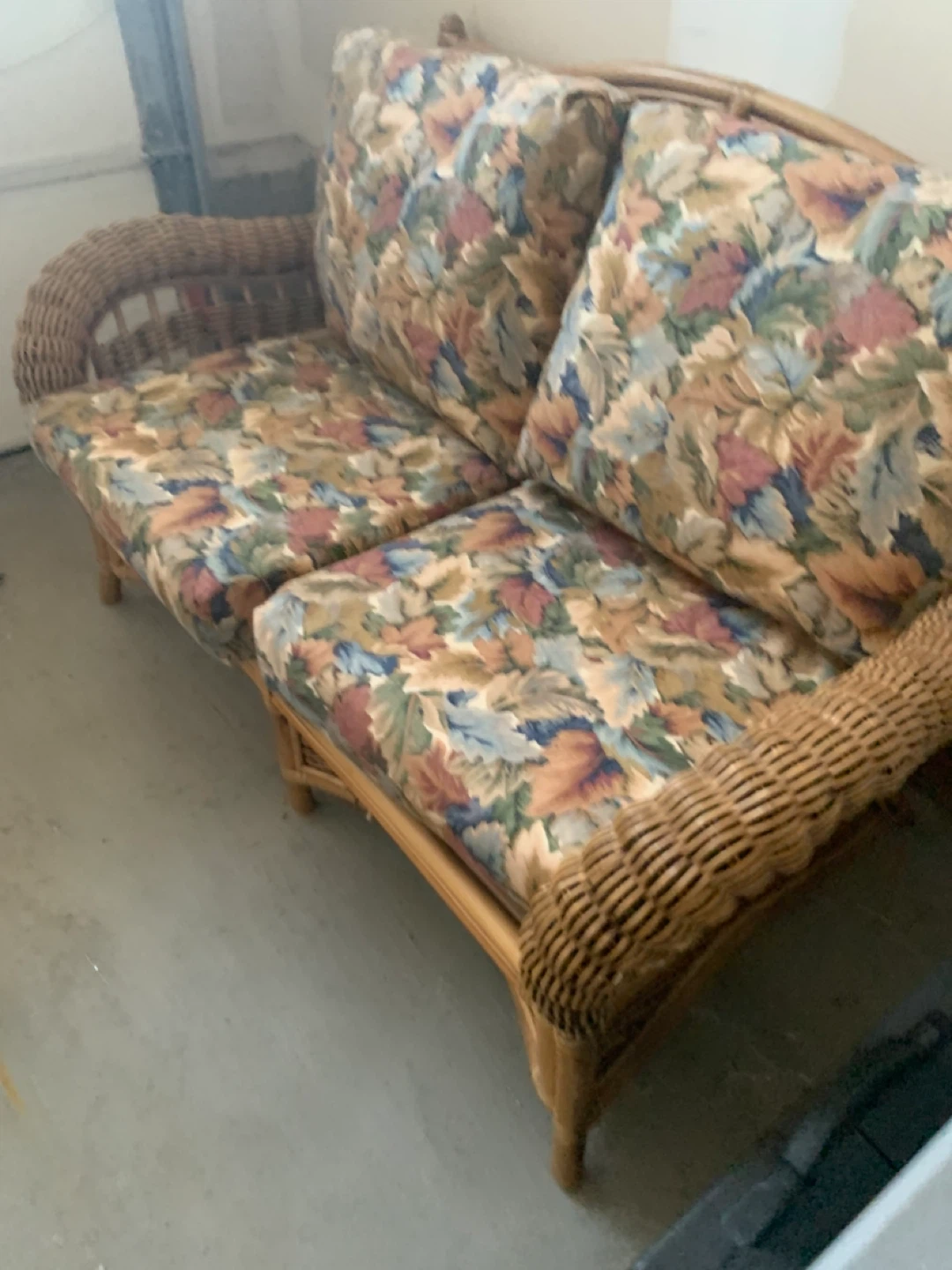 Wicker Loveseat with Floral Cushions