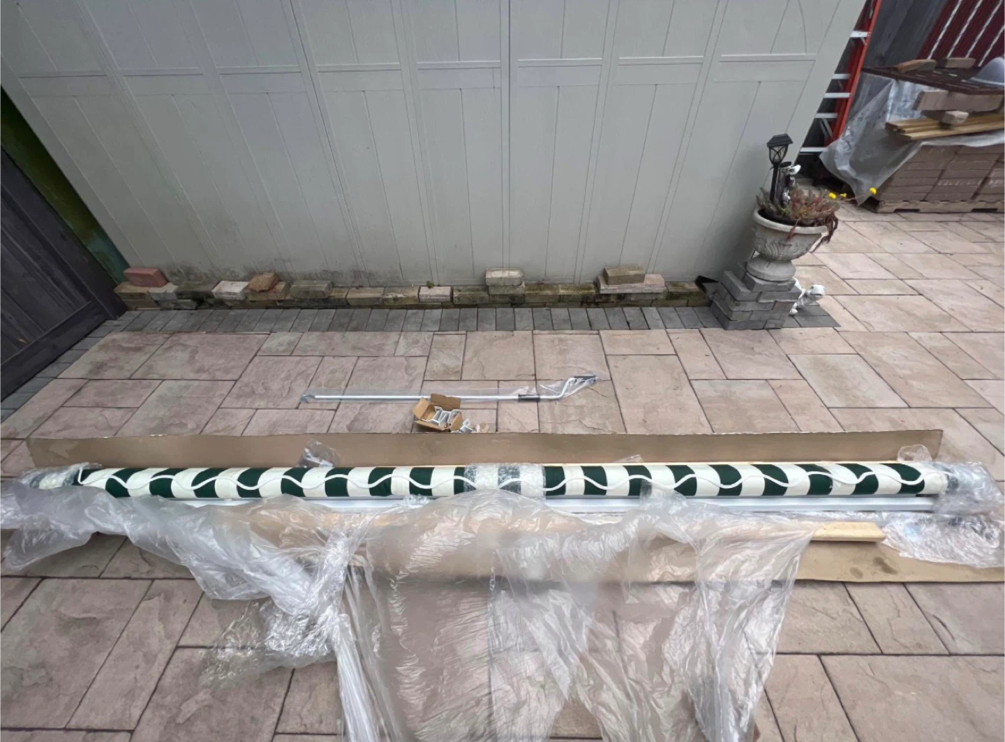 Green and White Striped Retractable Awning