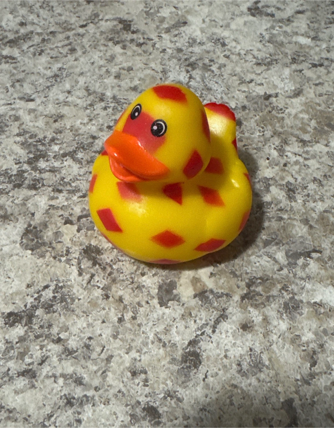 Yellow rubber duck with red spots