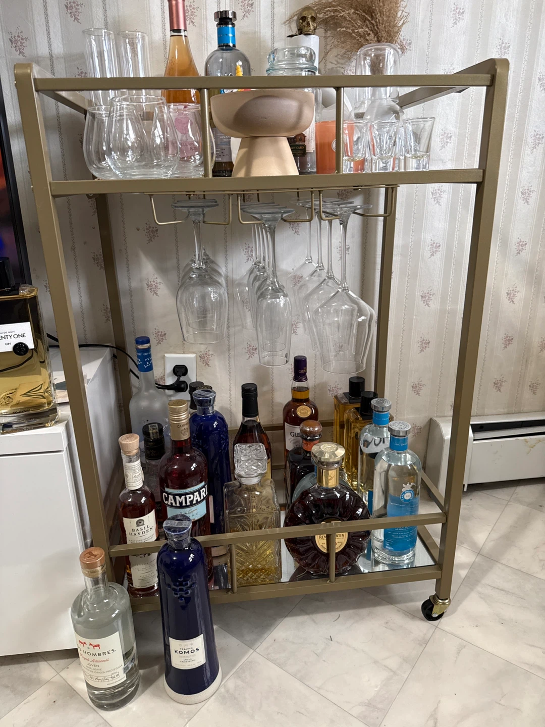 Gold Metal Bar Cart with Glasses and Liquor Bottles