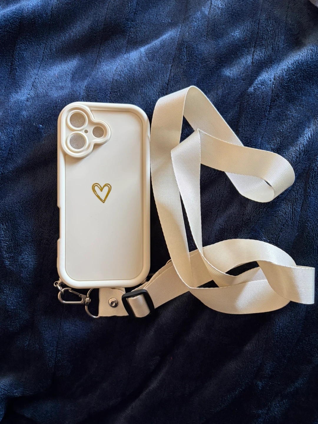 White phone case with gold heart and adjustable strap