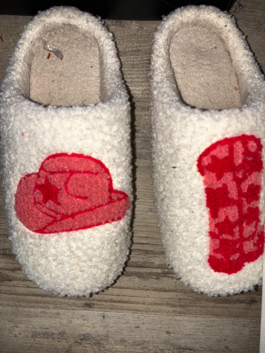 White fuzzy slippers with red cowboy hat and boots design
