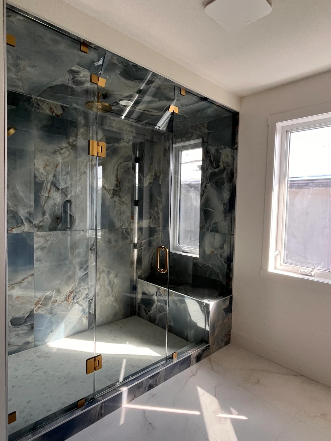 Custom Glass Shower Enclosure with Marble Tile Accents