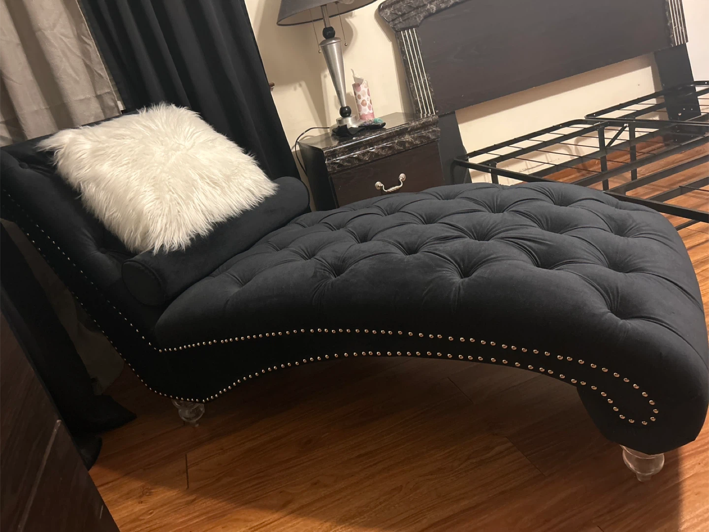 Black Tufted Chaise Lounge with White Faux Fur Pillow