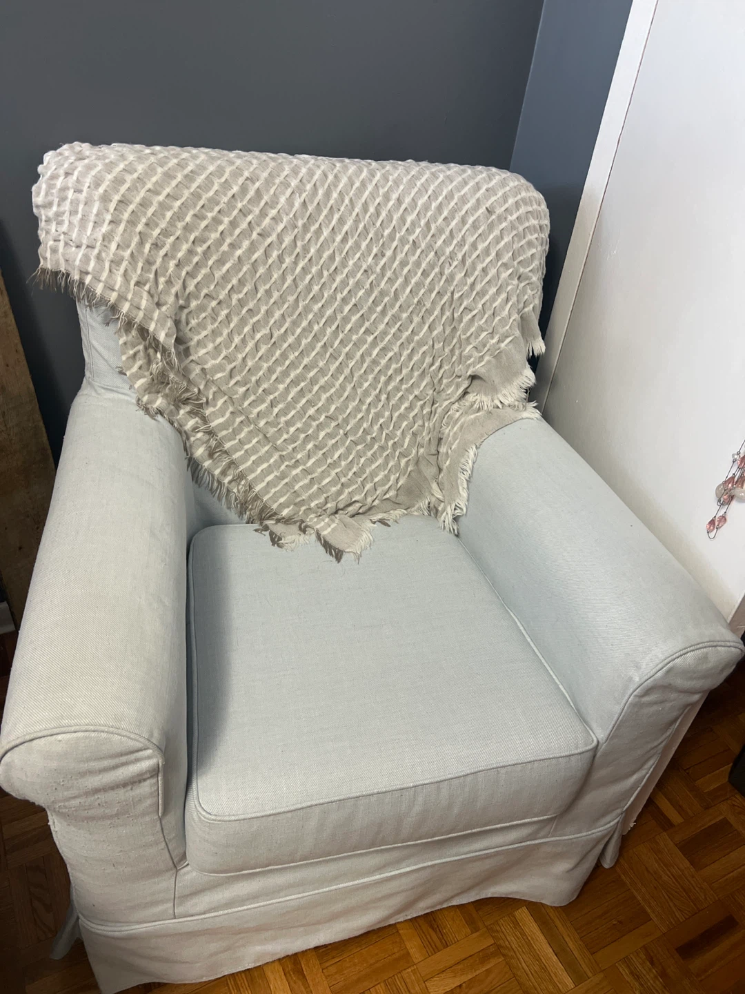 Light Blue Armchair with Throw Blanket