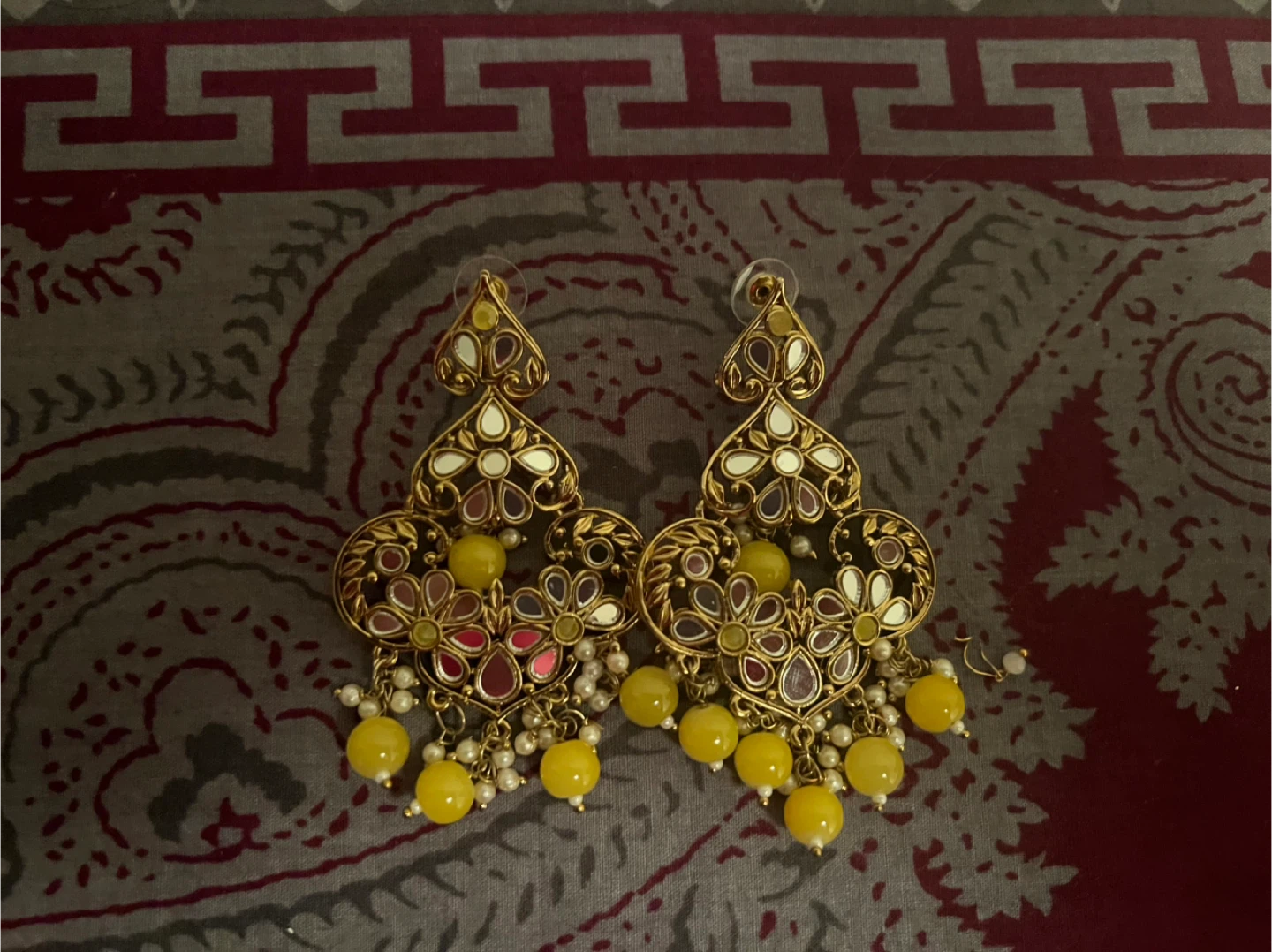 Gold coloured statement earrings with yellow beads