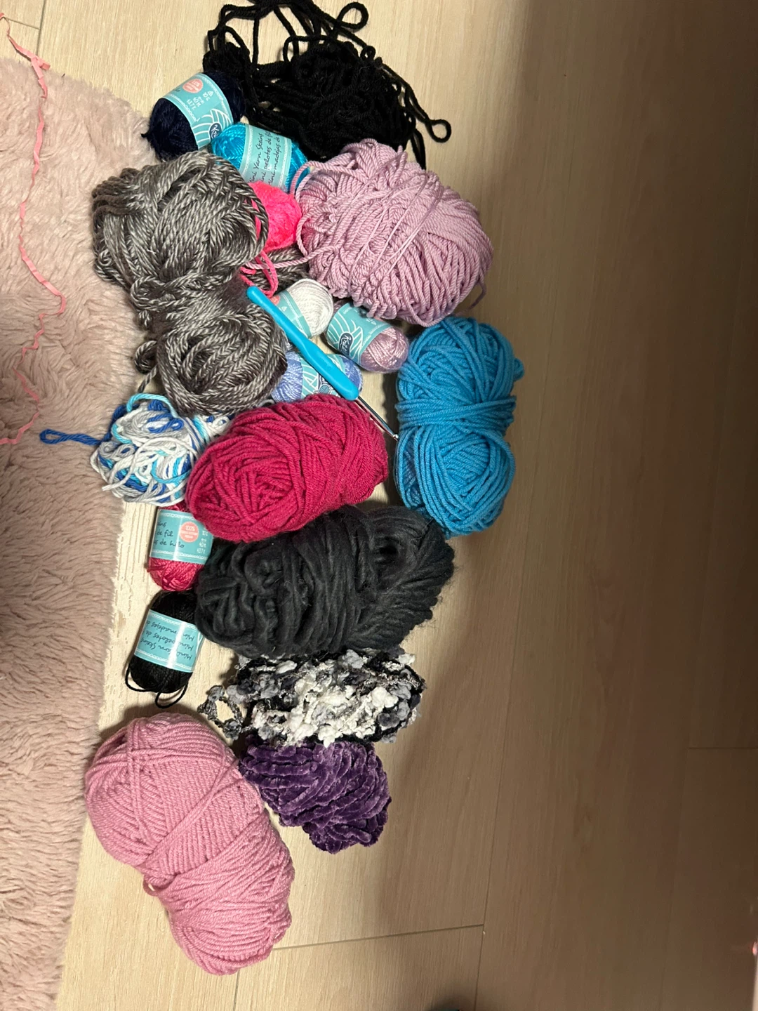 Assorted Yarn Skeins and Crochet Hook