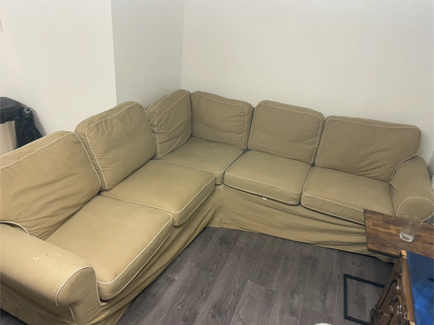 Sectional Sofa with Light Tan Fabric and White Piping