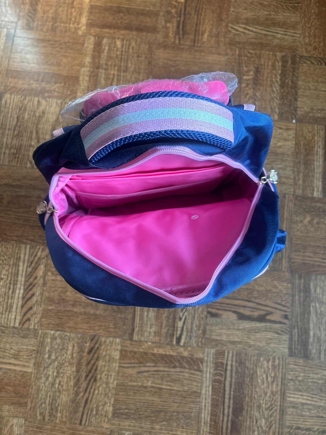 Blue rolling backpack with pink accents - photo 2