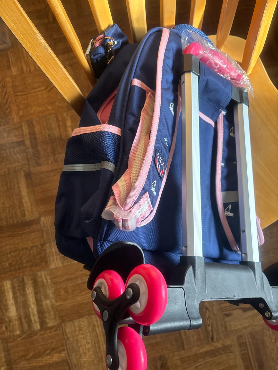 Blue rolling backpack with pink accents - photo 4
