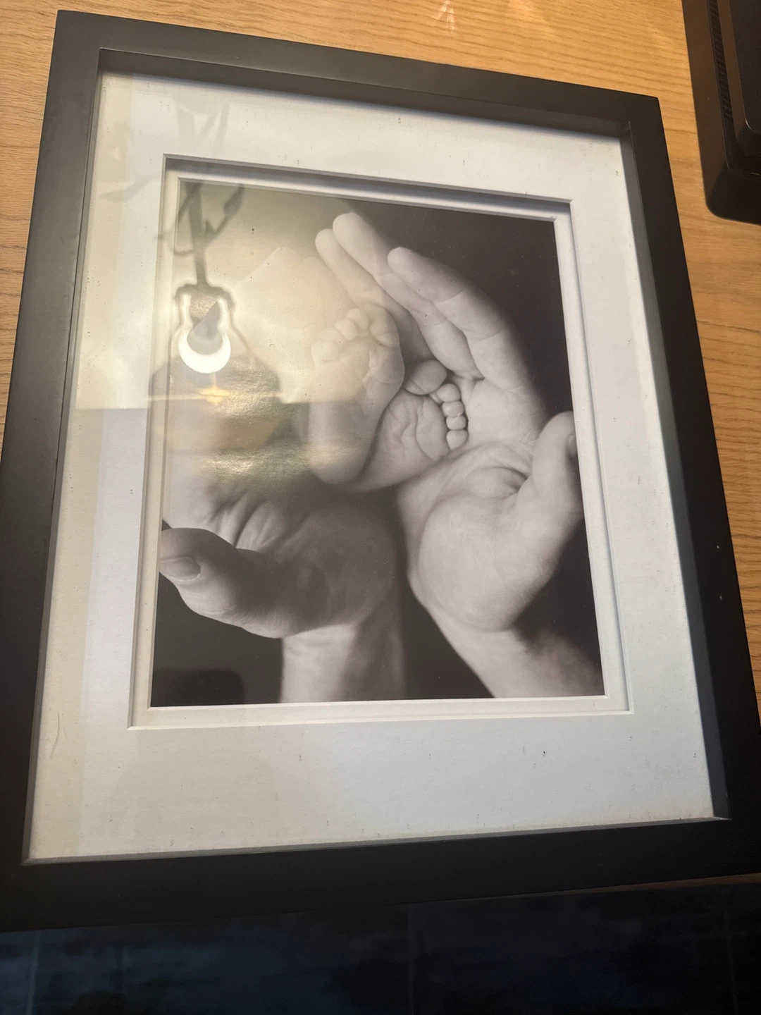 Framed Photo: Baby's Feet in Parent's Hands