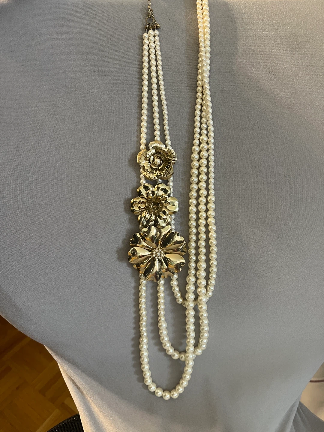 Multi-strand pearl necklace with gold flower accents