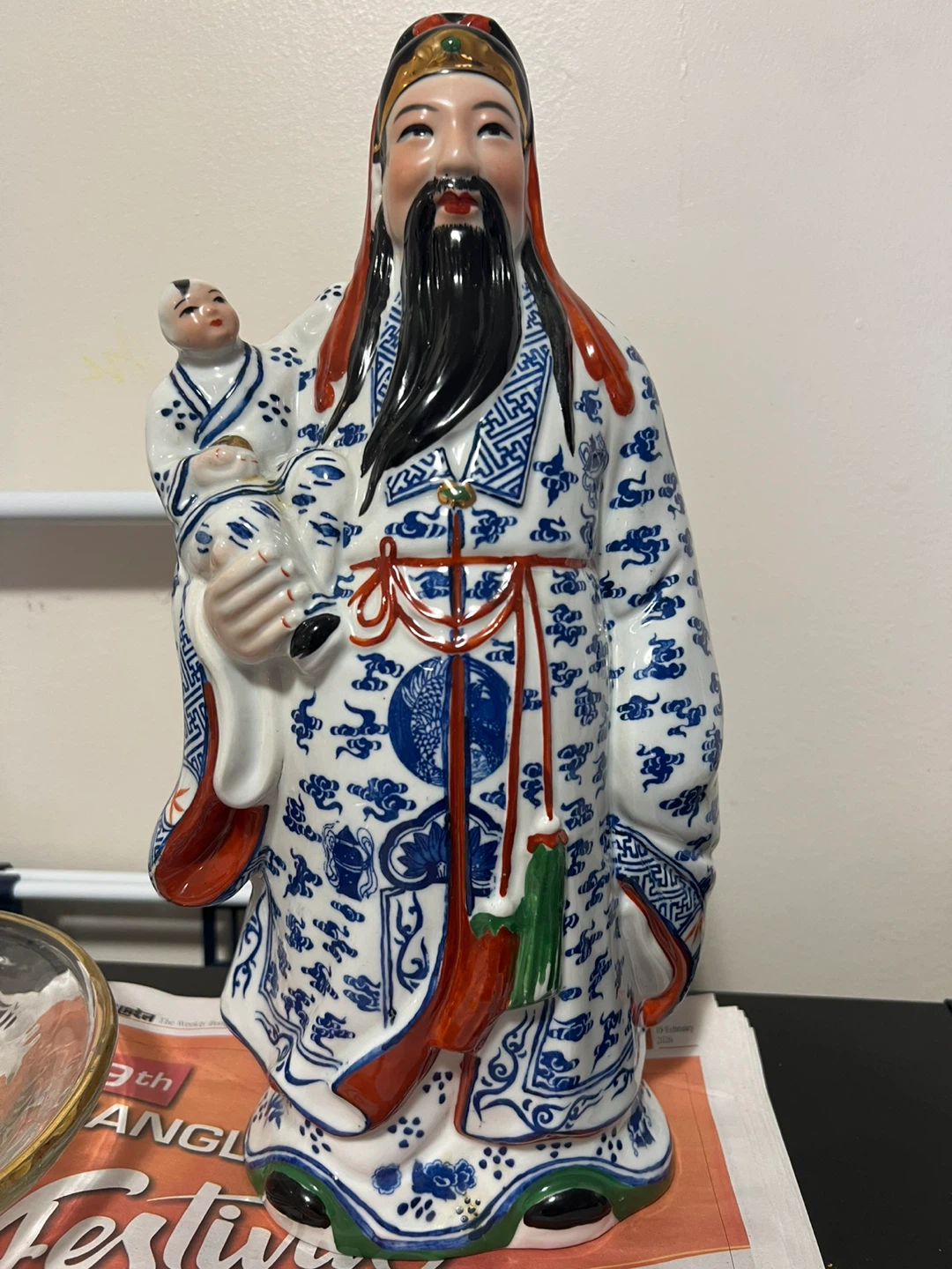 Ceramic Figurine of a Man Holding a Child