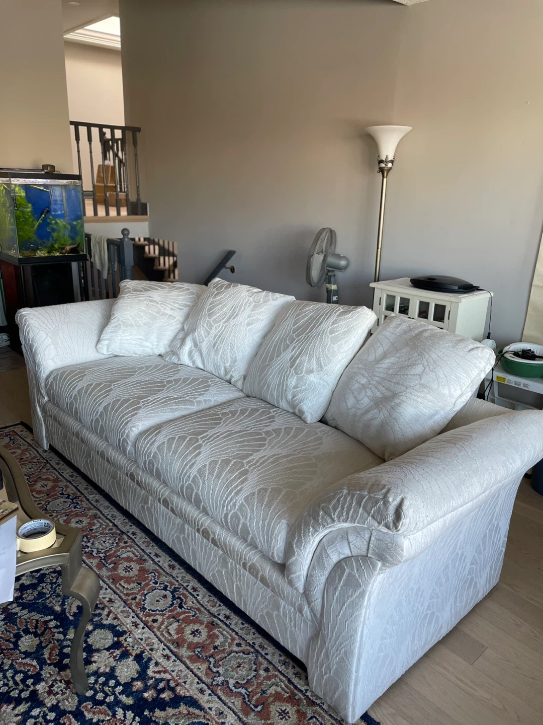 White patterned sofa with loose cushions