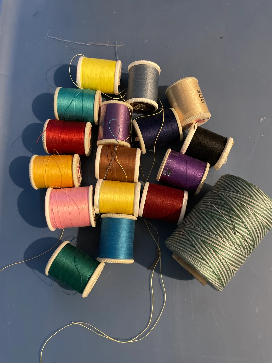 Assorted Spools of Sewing Thread and a Large Spool