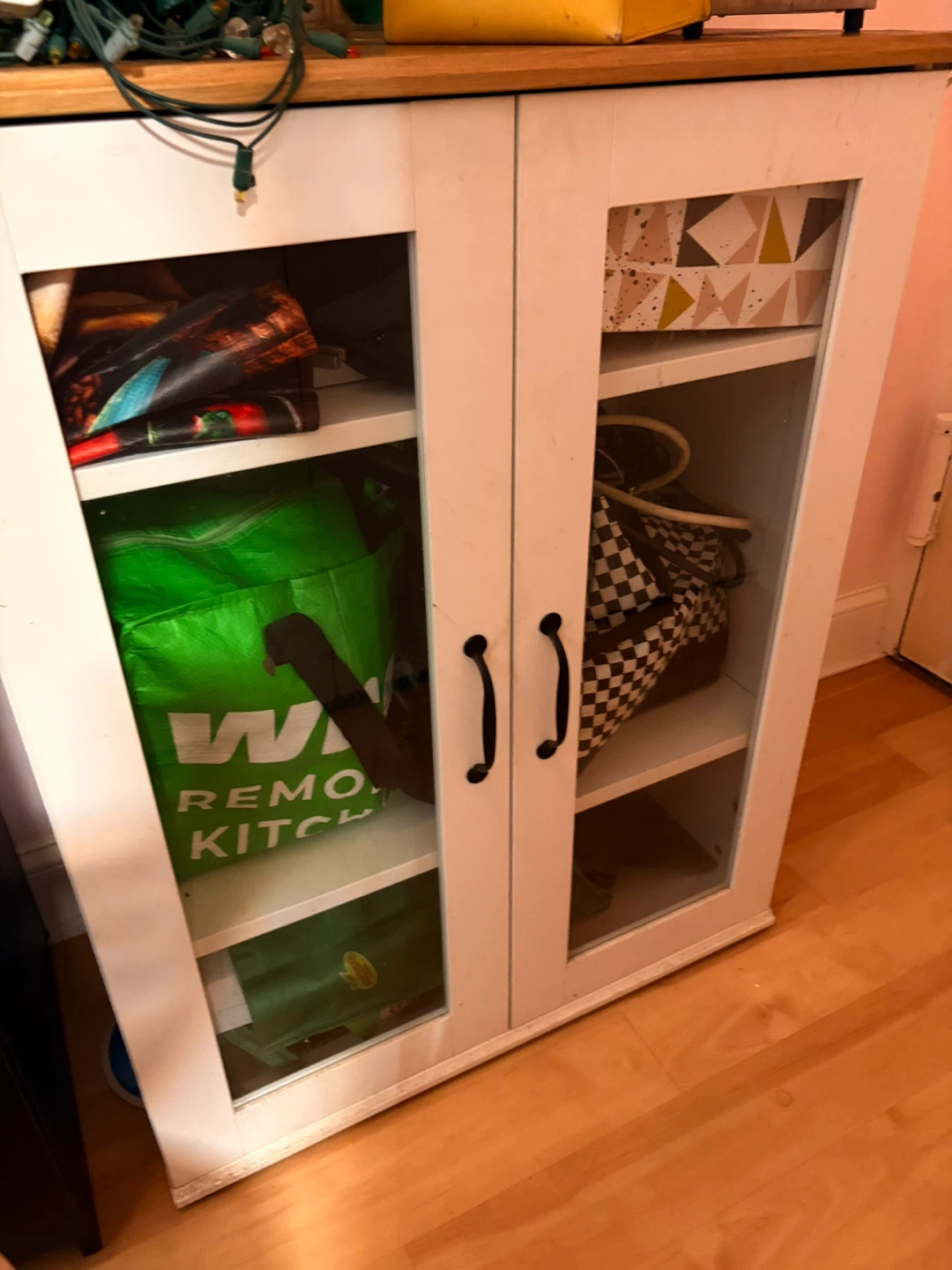 White two-door storage cabinet with glass doors