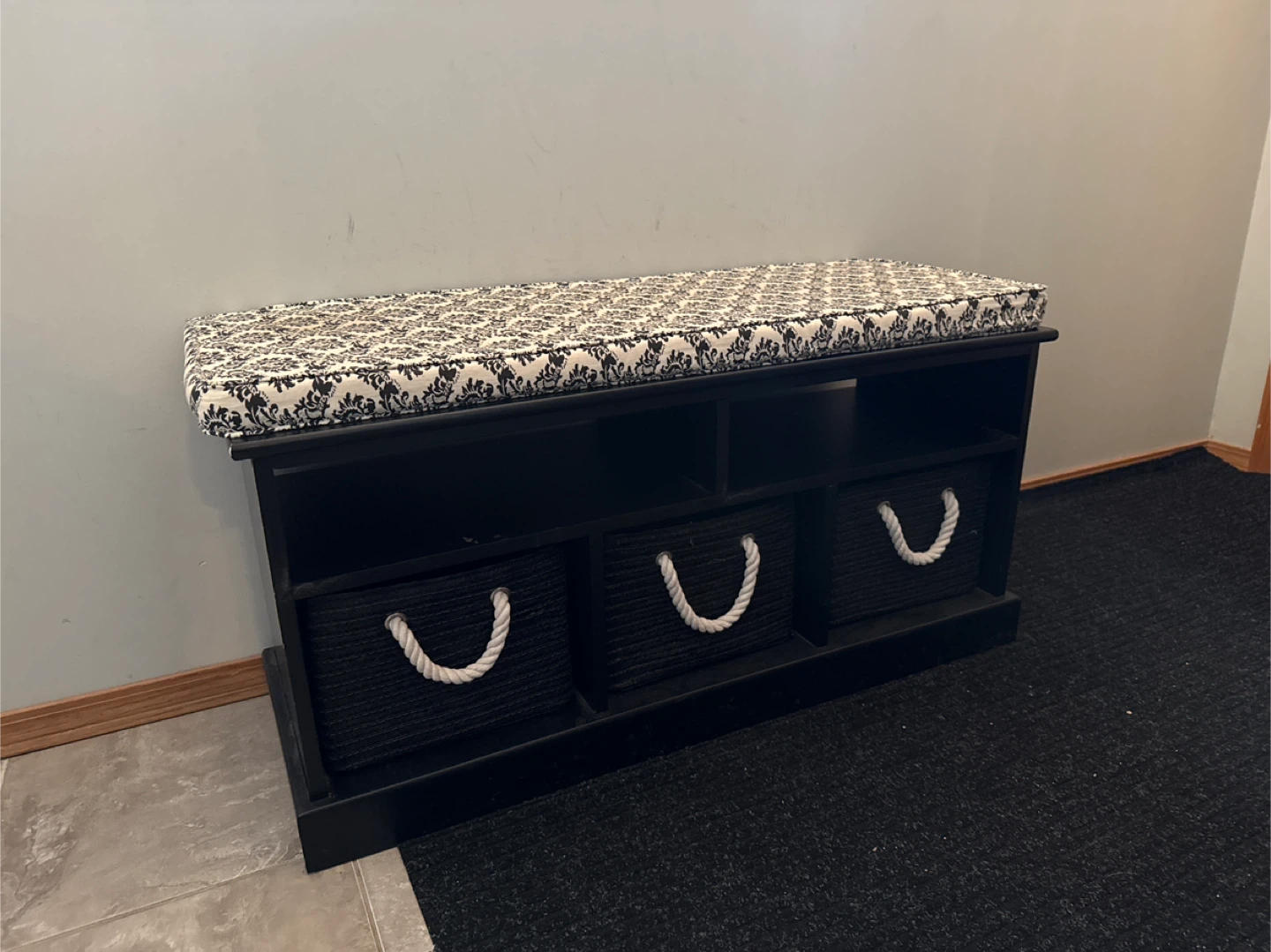 Black storage bench with damask cushion