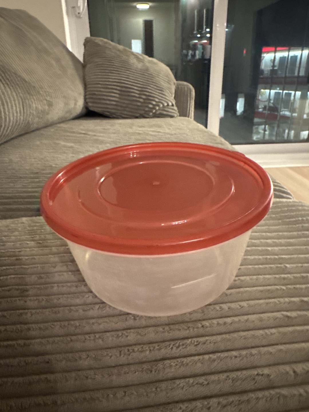 Plastic food storage container with red lid