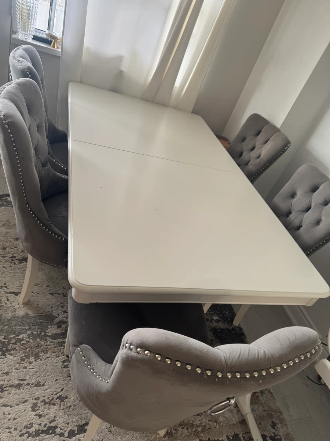 White Dining Table with Grey Tufted Chairs