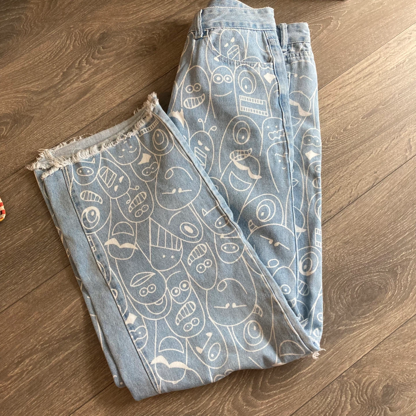 Light Wash Jeans with Cartoon Faces Print