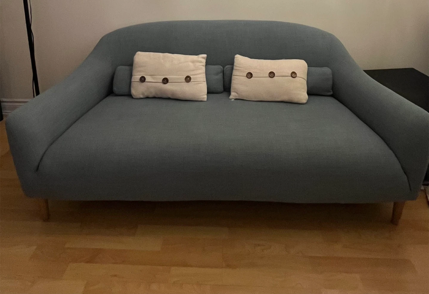 Blue loveseat sofa with decorative pillows