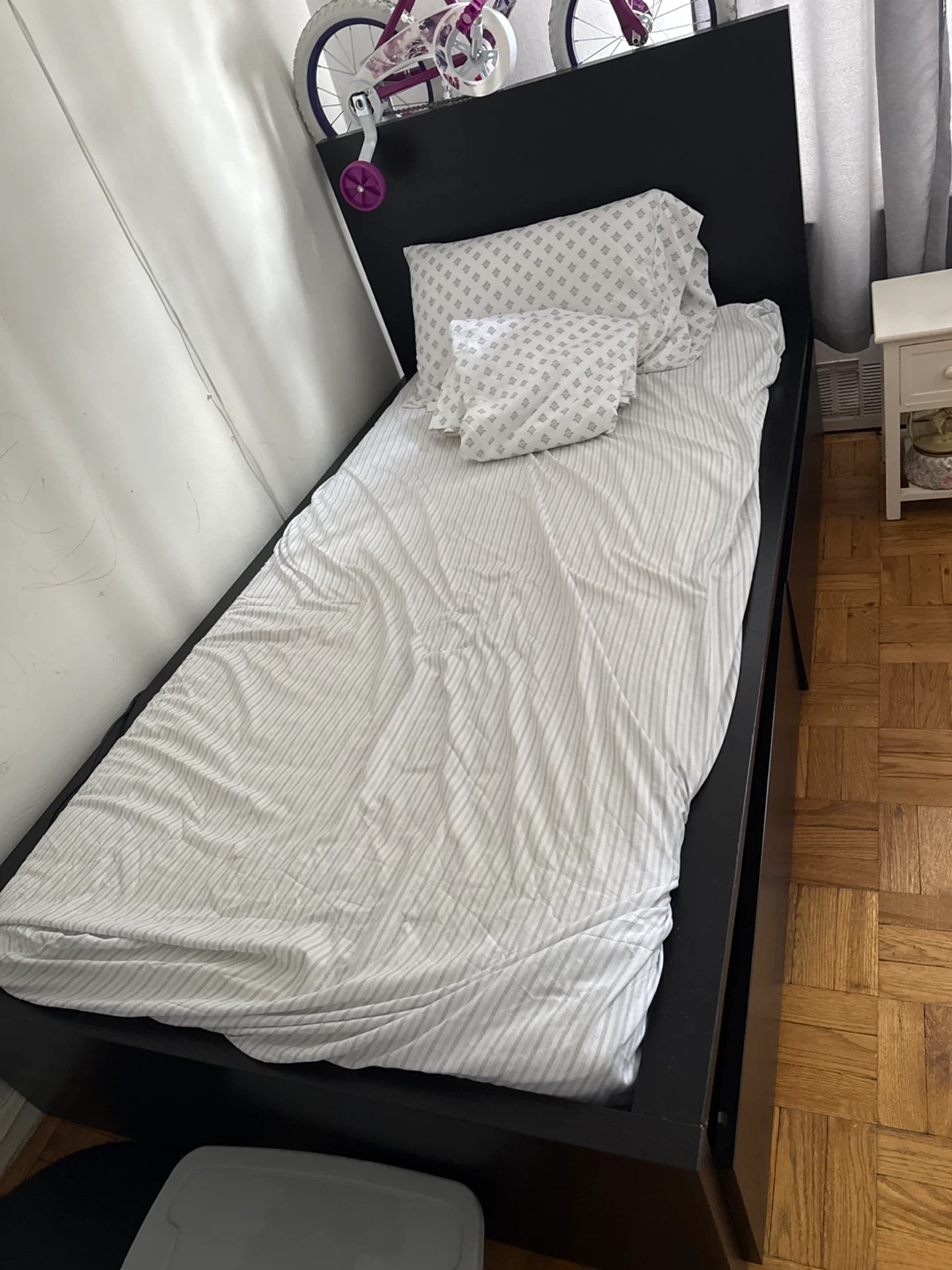 Black Twin Bed Frame with Striped Bedding