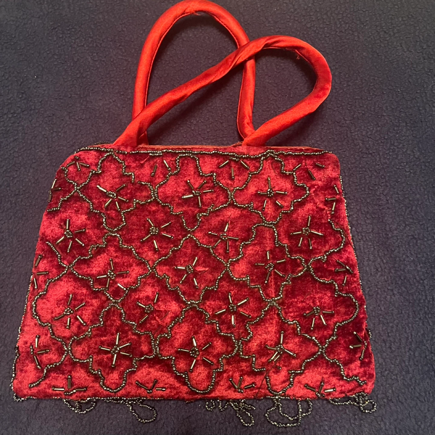Red beaded evening purse with small chain as design