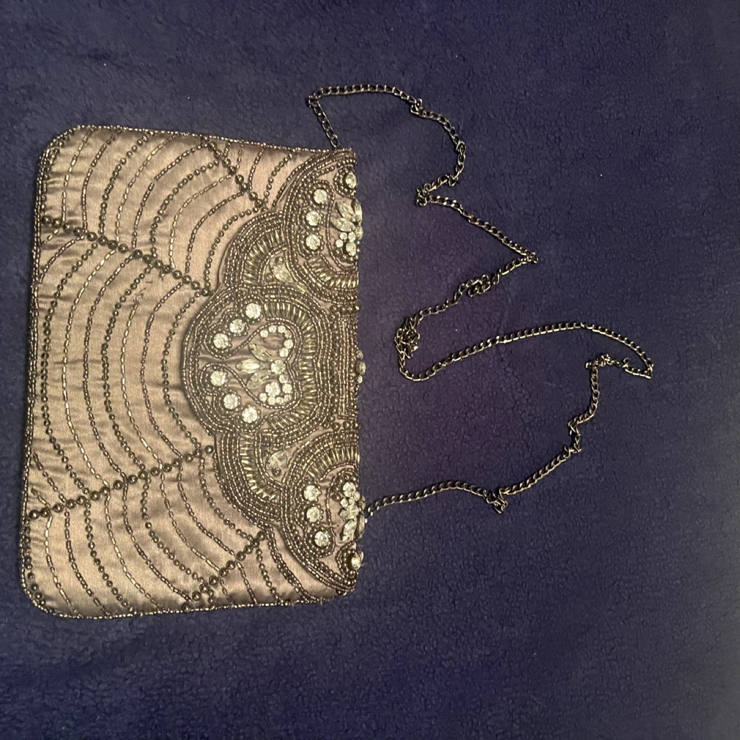 Silver clutch style purse with white stones on the front