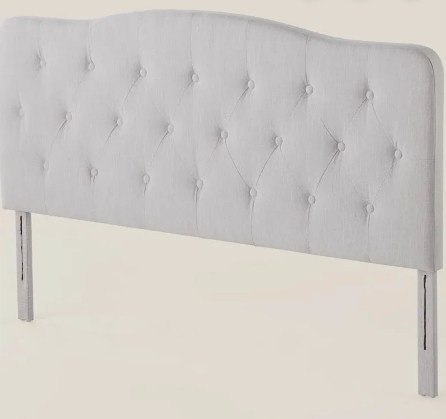 tufted upholstered headboard with a curved top