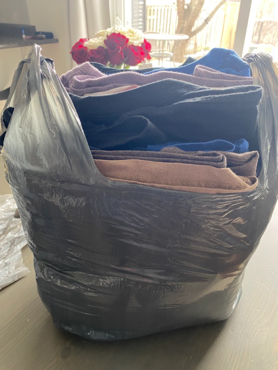 Bag of assorted sweaters and clothing