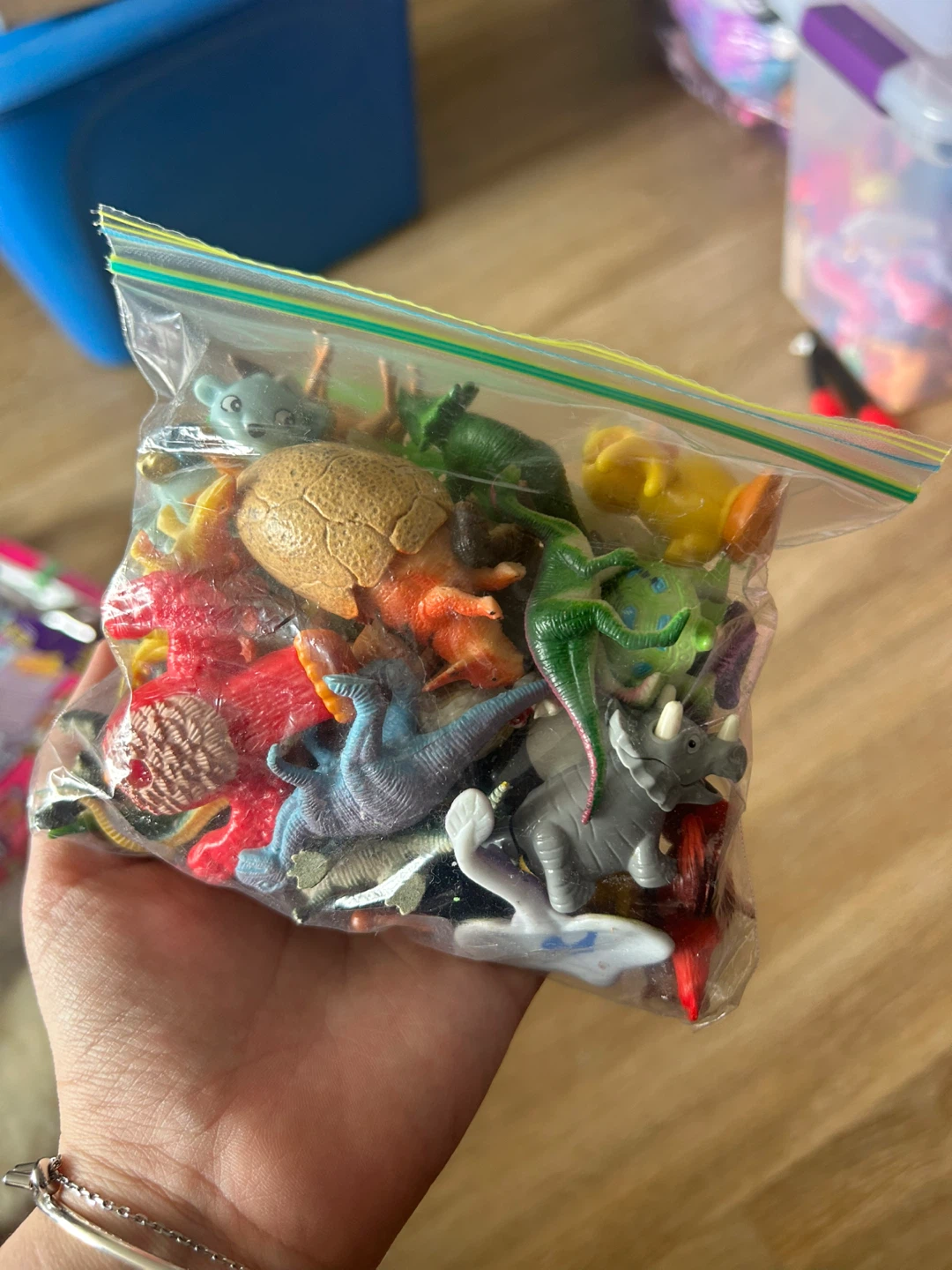 Bag of various small toy dinosaurs and animals