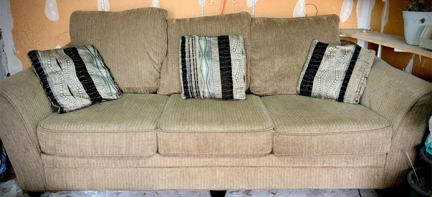 Tan Sofa with Decorative Pillows and solid wood dining table - photo 2