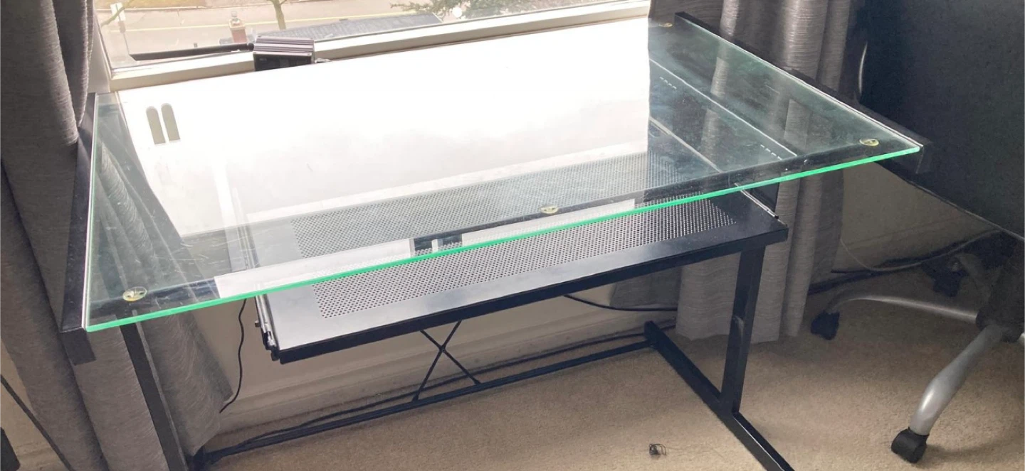 Glass top desk with black metal frame