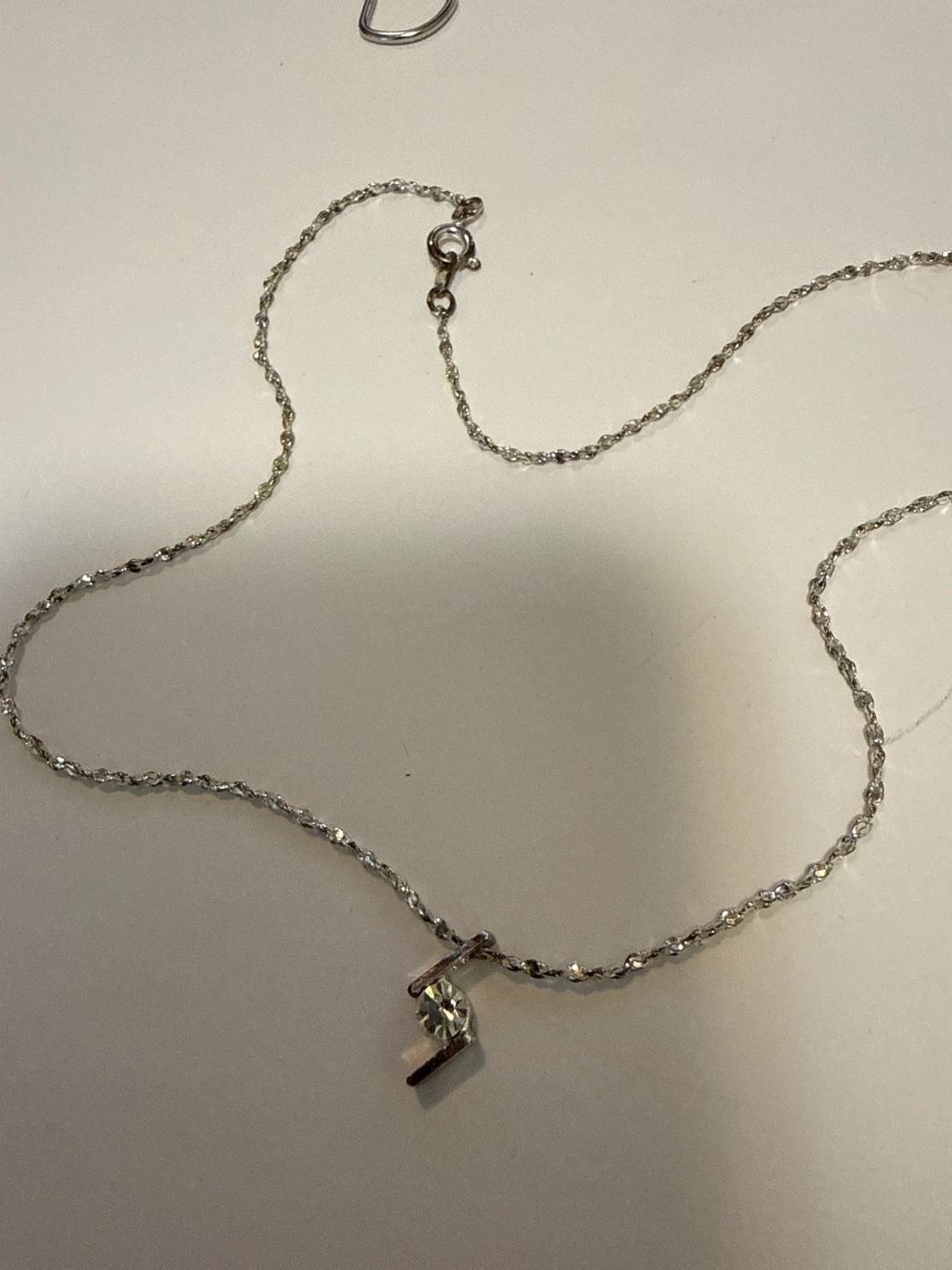 Silver tone pendant necklace with clear stone