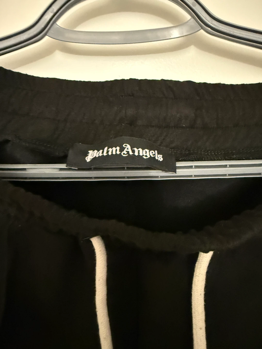 Black track pants with Palm Angels style and side stripe design. - photo 4