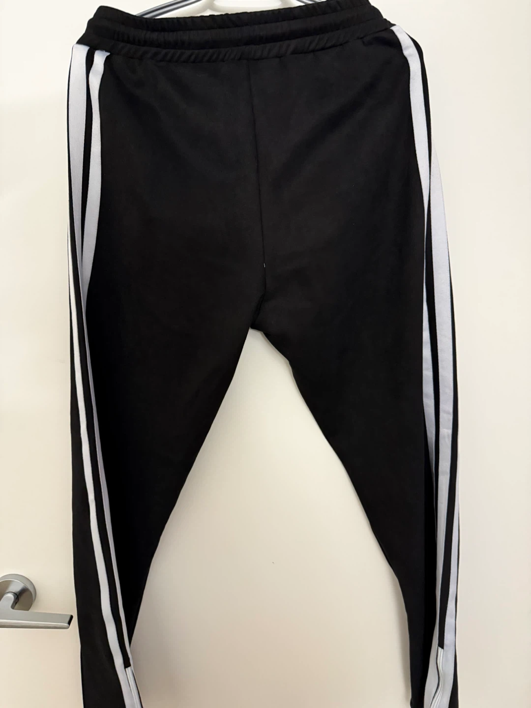 Black track pants with Palm Angels style and side stripe design. - photo 2