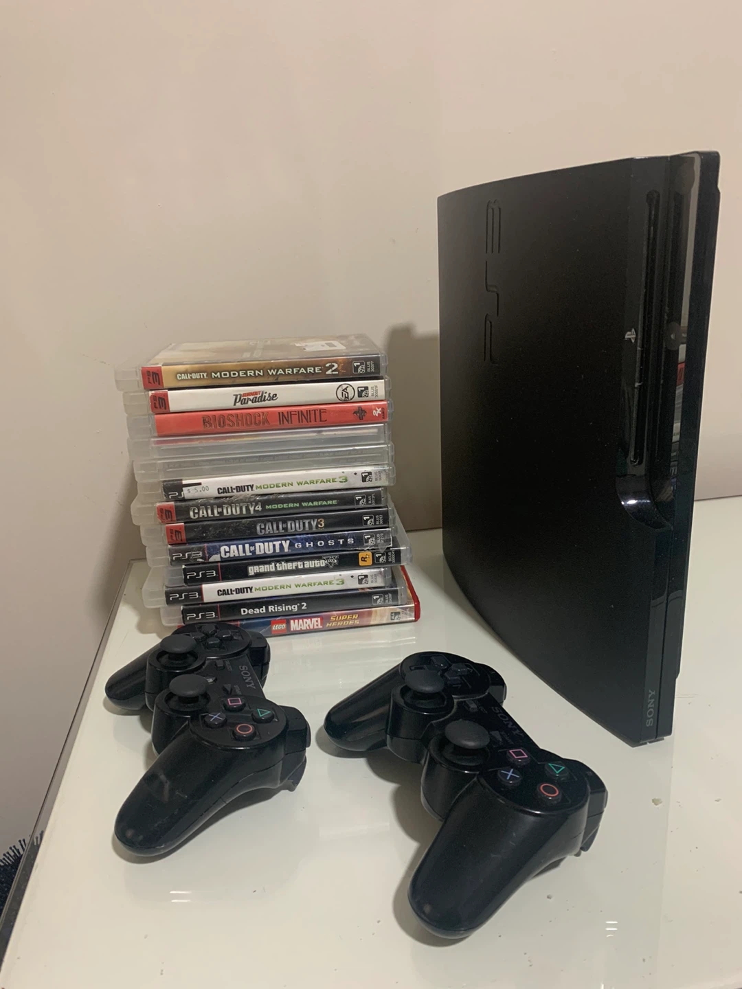 Sony PlayStation 3 slim Console with Games and Controllers