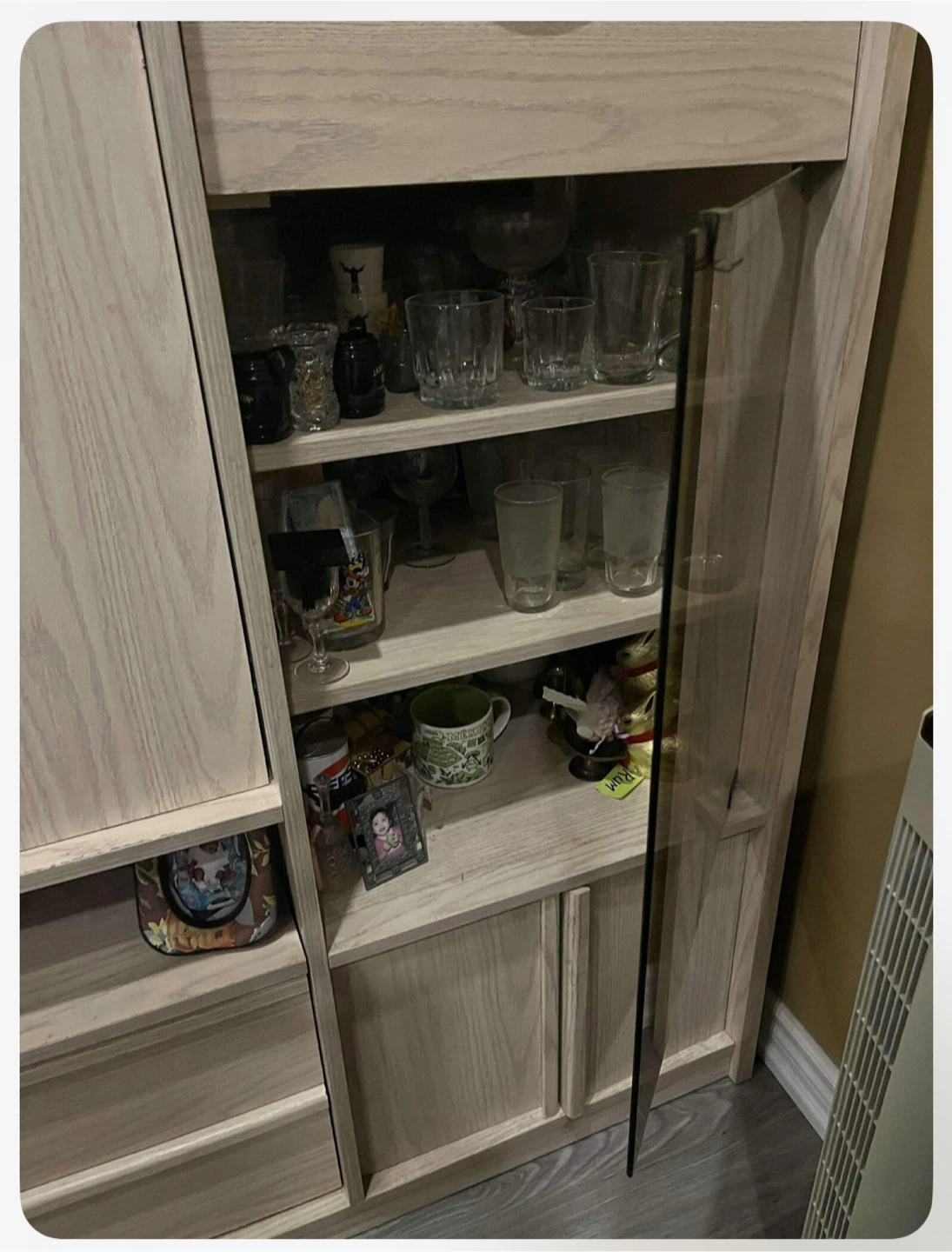 Light Wood Bar Cabinet with Glassware and Liquor Bottles