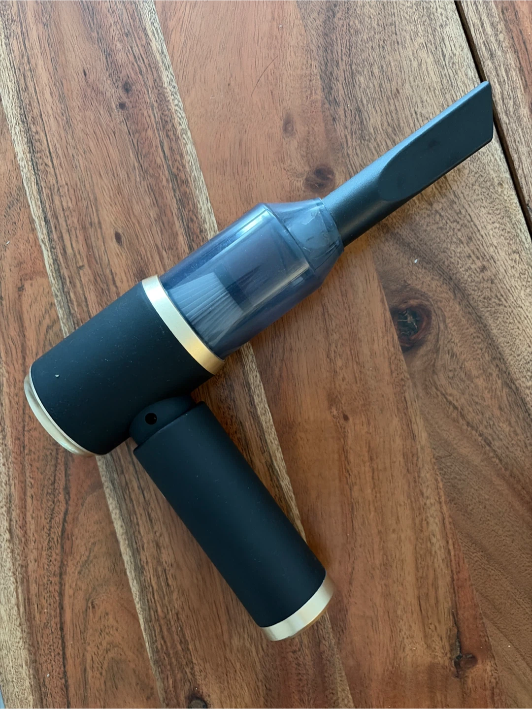 Black handheld vacuum cleaner with crevice tool