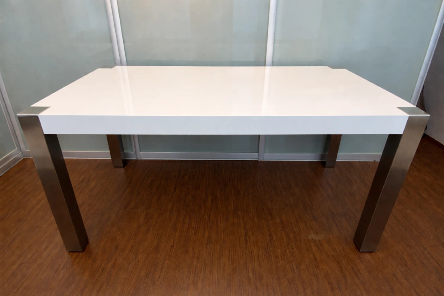 Modern white dinner table with silver legs