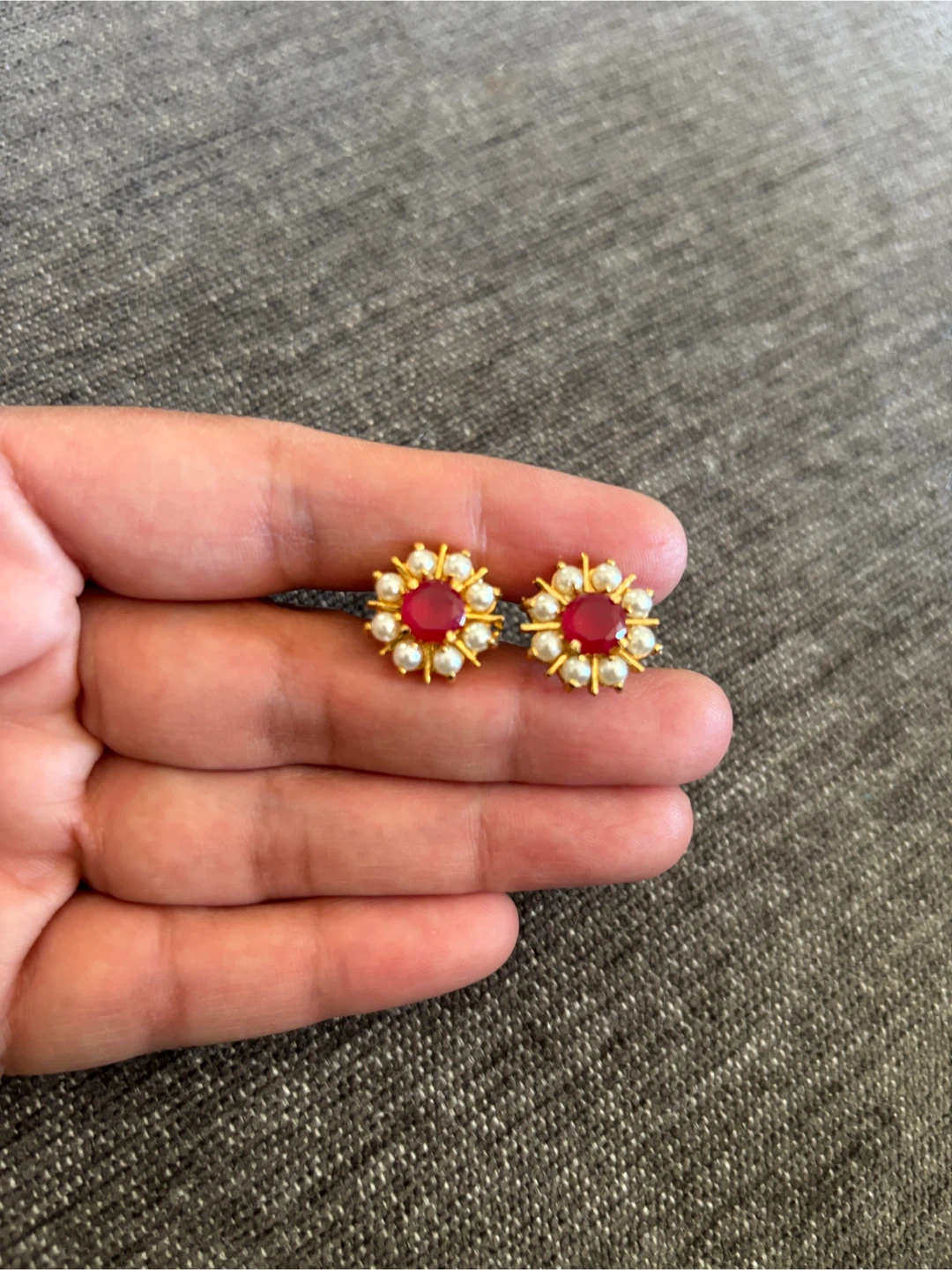 Gold tone stud earrings with red and pearl accents