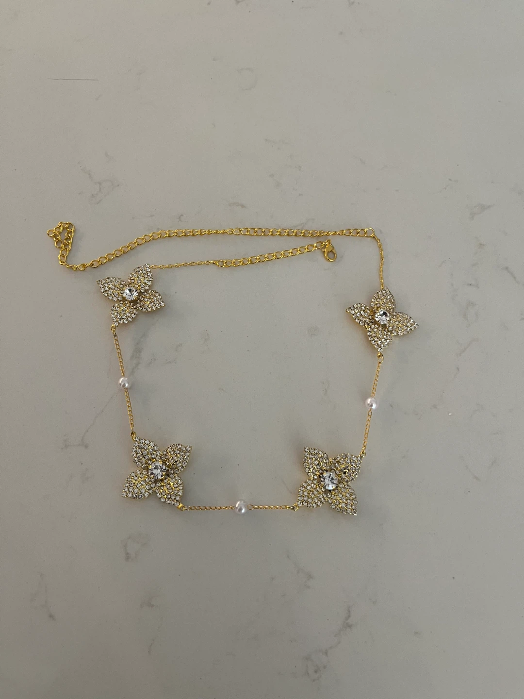 Gold-tone necklace with clover charms and pearls