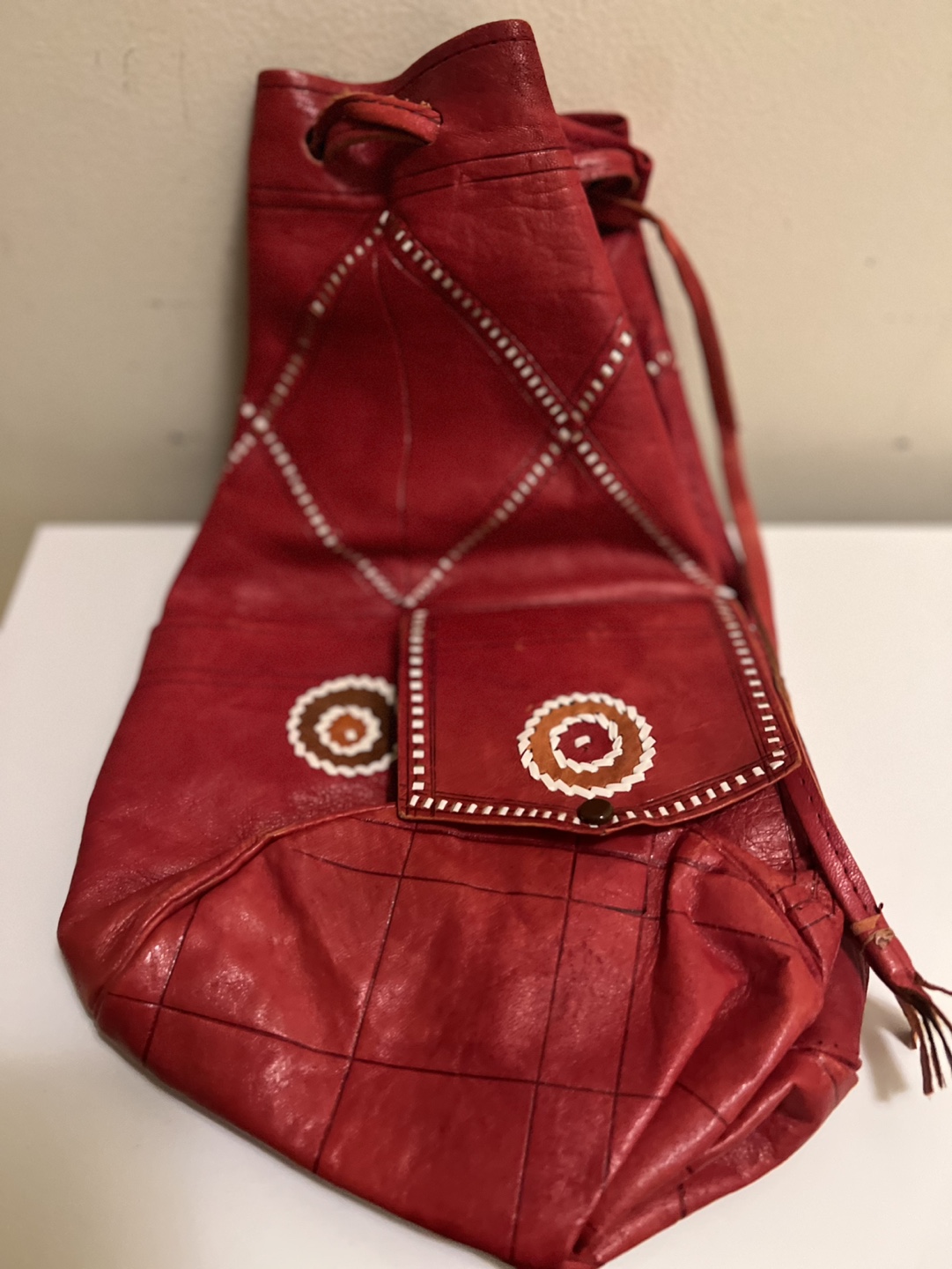 Red Leather Drawstring Bag with Decorative Stitching